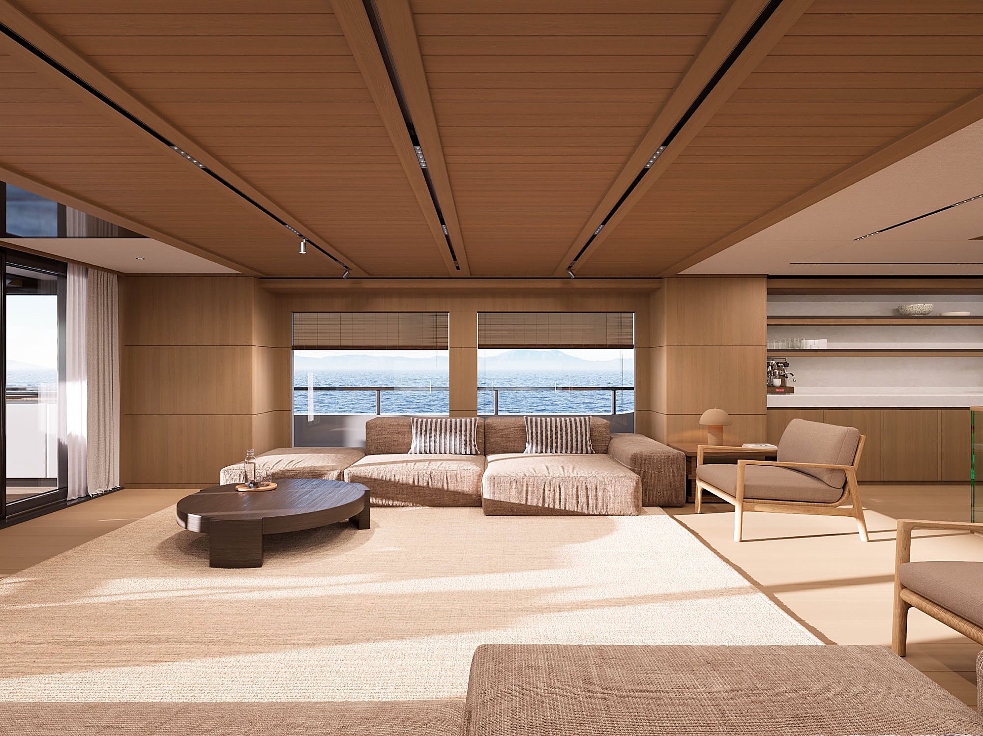 Living room lounge with a beige sectional sofa, dark round coffee table, and a wide window open to the deck.