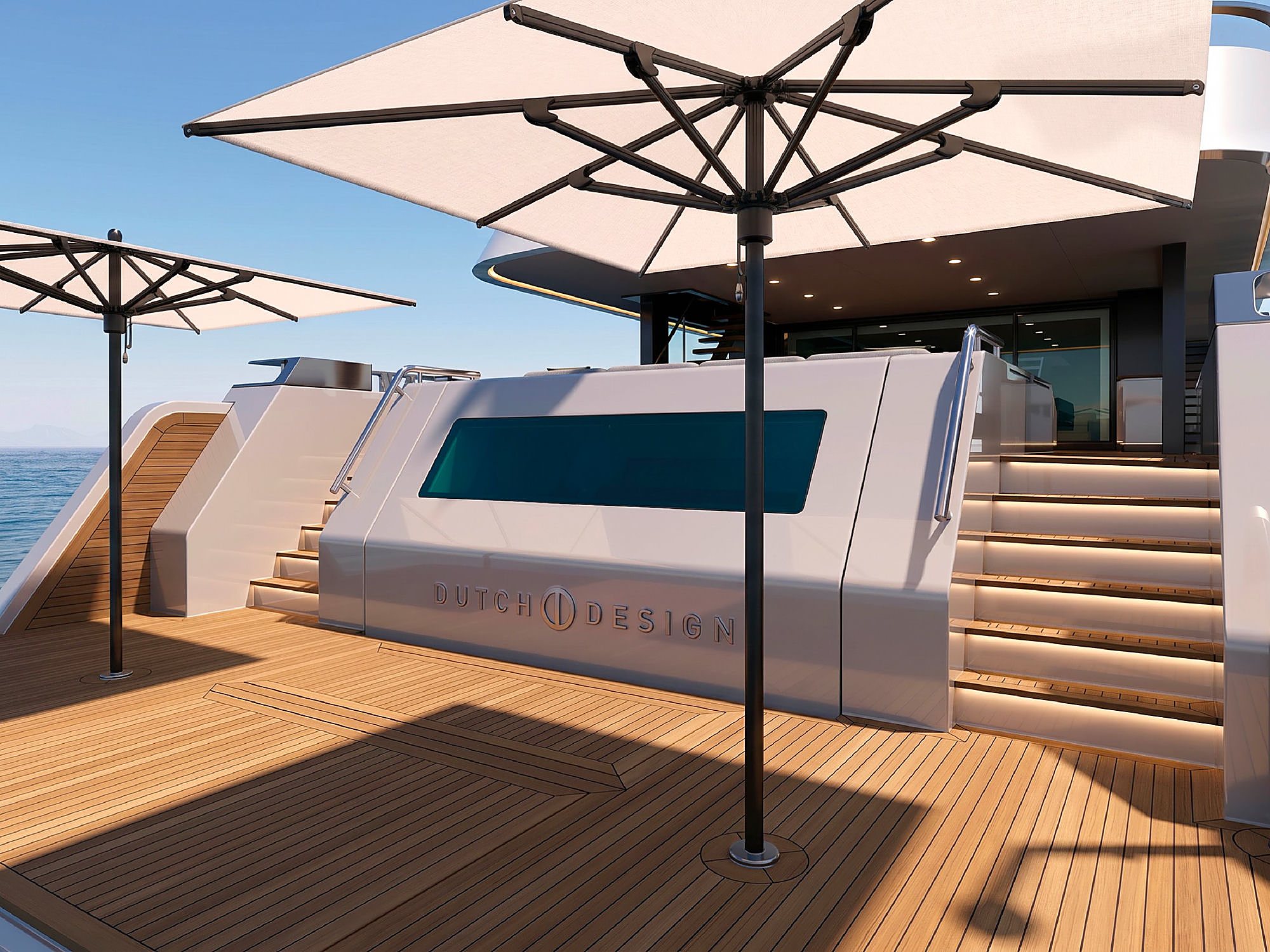 Wraparound sundeck seating heaped with navy and grey cushions above a glass-fronted plunge pool.
