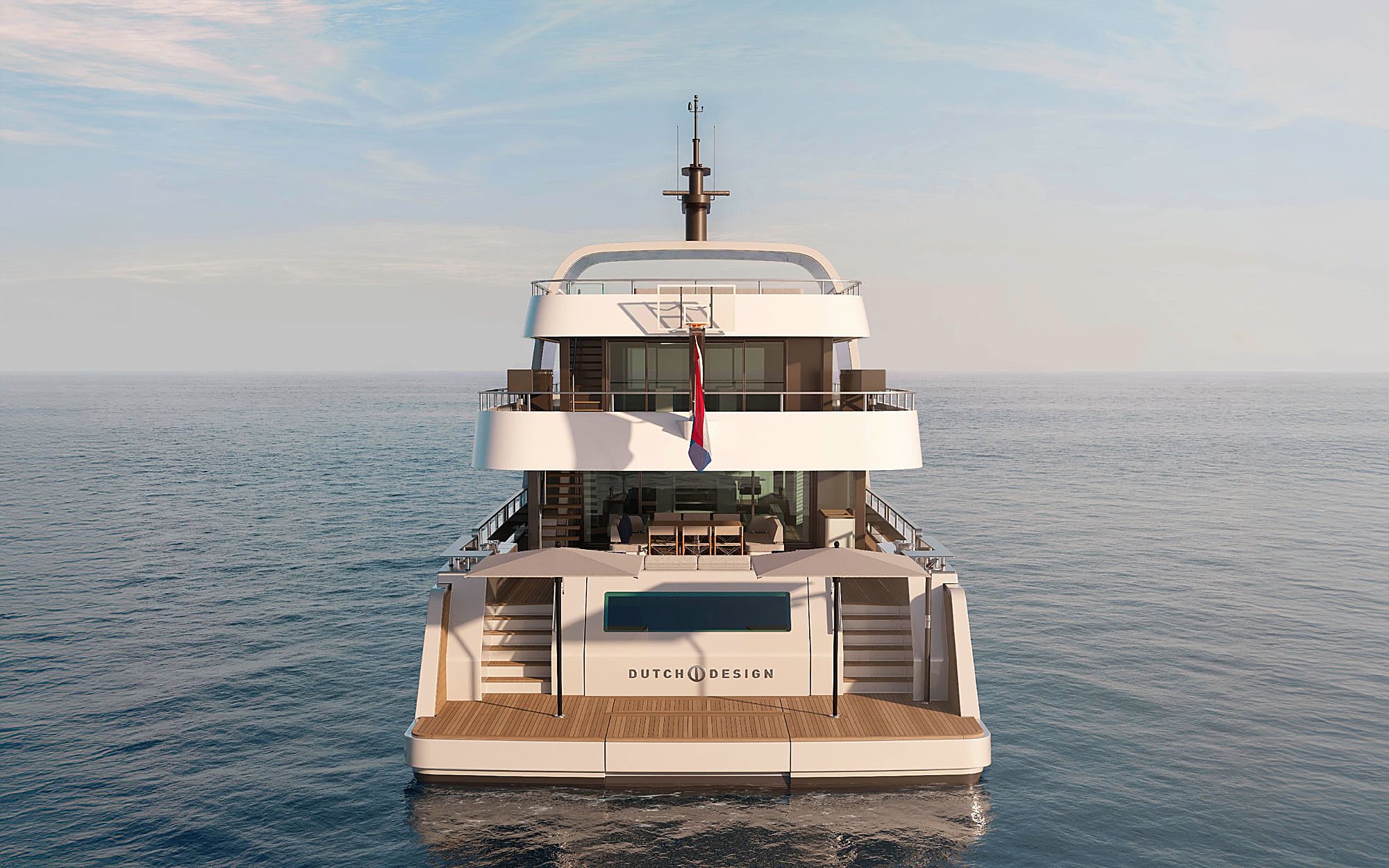 Stern view of the yacht at anchor, with the Dutch Design nameplate lettered across the transom.