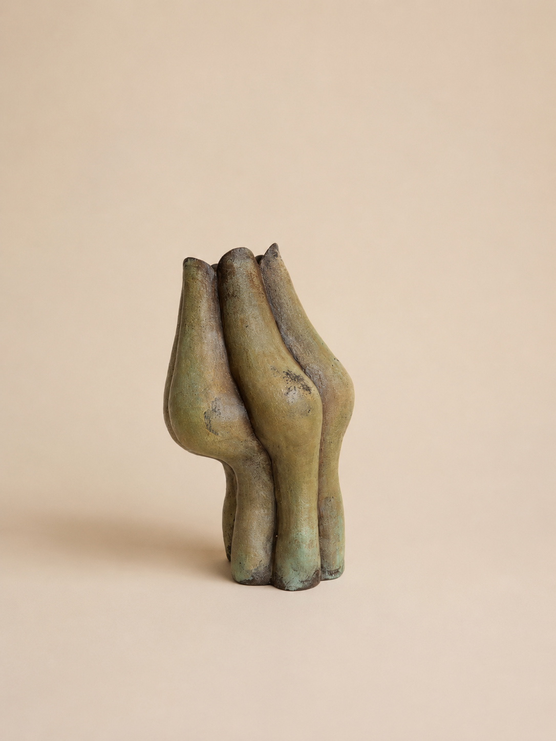 Ceramic vessel sculpture by Loriann Stevenson with three joined organic forms, in a mottled olive and umber glaze.