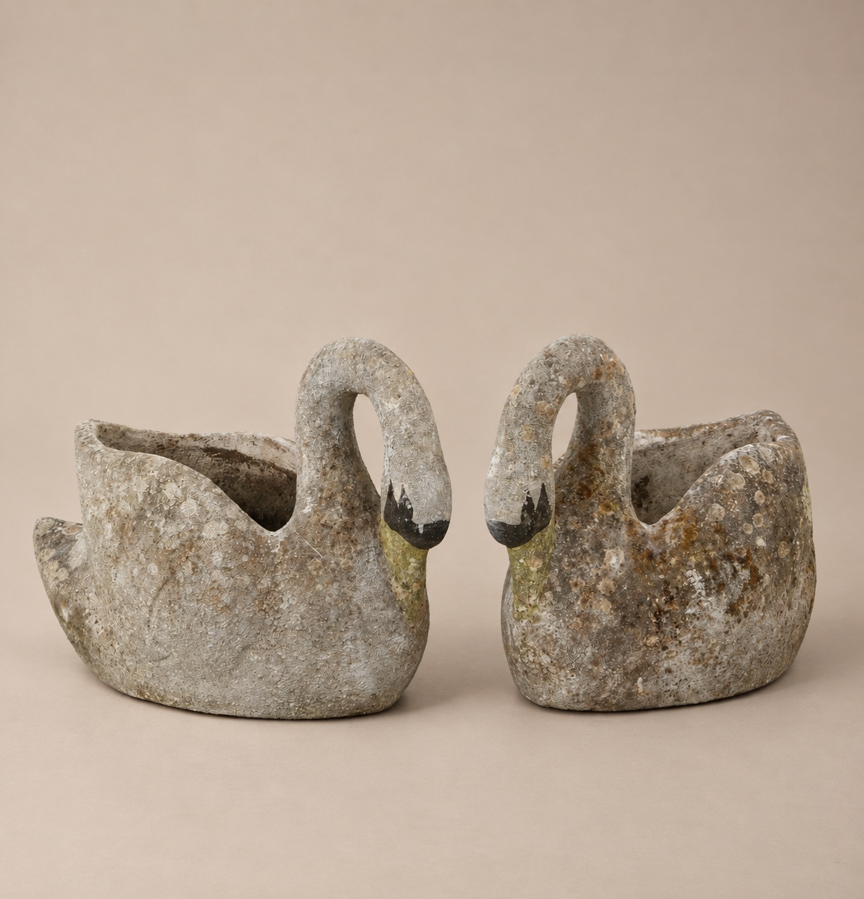 Two vintage concrete swan planters facing each other, with weathered lichen-toned finishes, from France, 1960s.