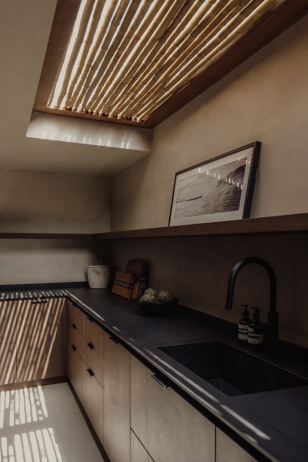 Kitchen skylight detail with a bamboo-slat ceiling filtering light above the counter.